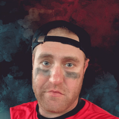 Man in Baseball Cap and Red Tough Break Shirt