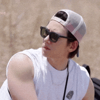 Man in Baseball Cap and Sunglasses on Beach