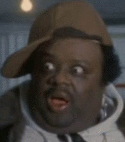 Man in Baseball Cap and Tie Making Funny Face