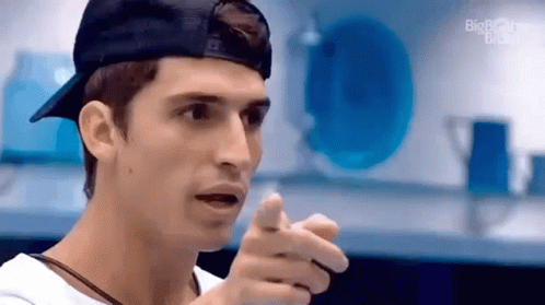 Man in Baseball Cap and White Shirt Pointing