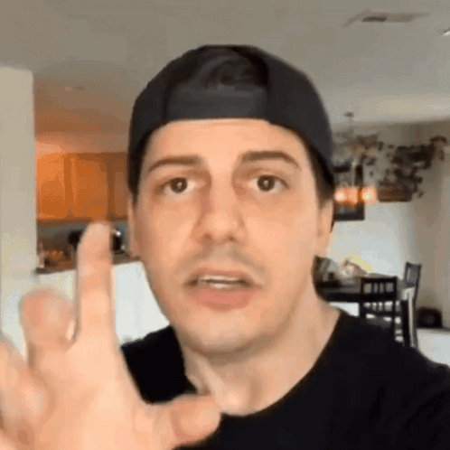 Man in Baseball Cap Giving Middle Finger