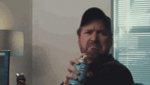 Man In Baseball Cap Holding Soda GIF