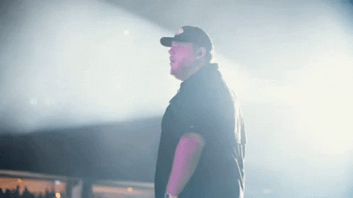 Man in Baseball Cap Standing on Stage