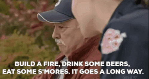 Man in Baseball Cap Talking to Man in Red Jacket