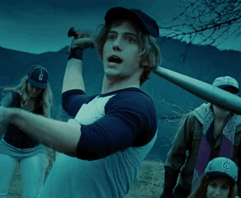 Man in Baseball Cap with Letter C Holding Bat