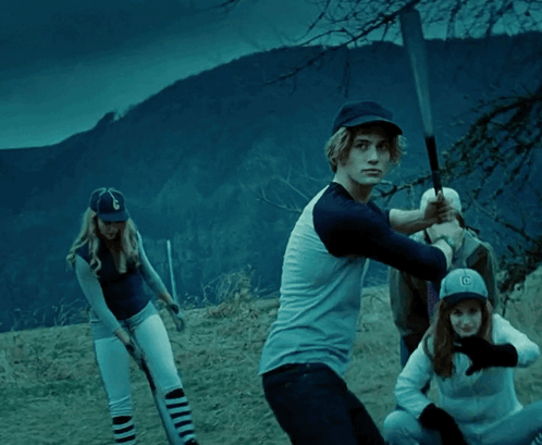 Man in Baseball Cap with Letter G Swings Bat