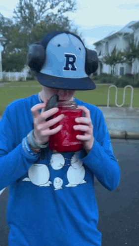 Man in Baseball Cap With Letter R