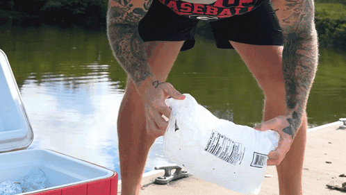 Man in Baseball Shirt Holding Bag of Ice