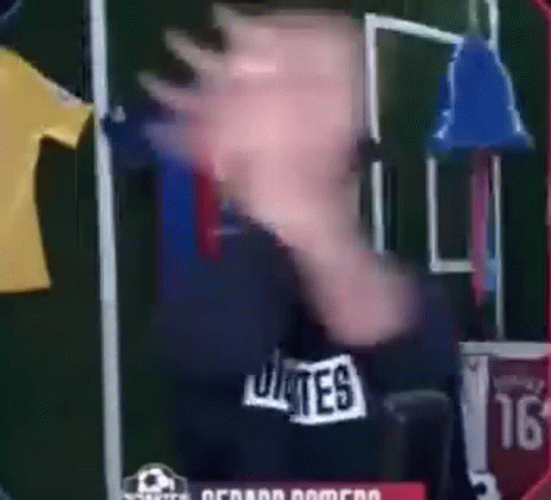 Man in Bates Shirt in Front of Soccer Field