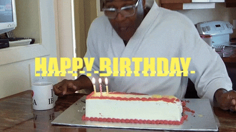 Man In Bath Robe Blowing Birthday Candles GIF