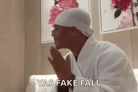 Man in Bathrobe and Hat Praying on Couch
