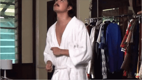 Man In Bathrobe In Front Of Closet GIF