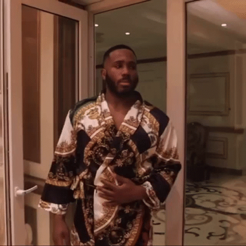 Man in Bathrobe Standing in Doorway