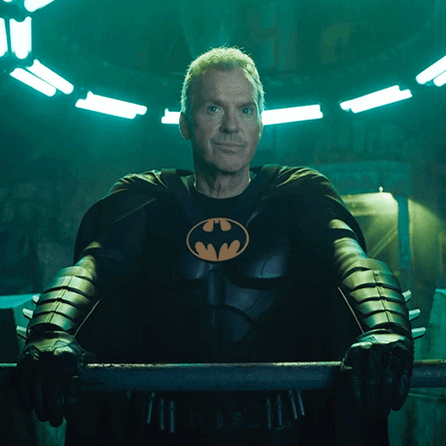 Man in Batman Costume Holding Bar