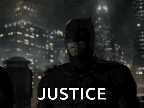 Man in Batman Costume Saying Justice