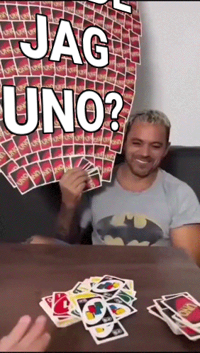 Man in Batman Shirt Playing Card Game