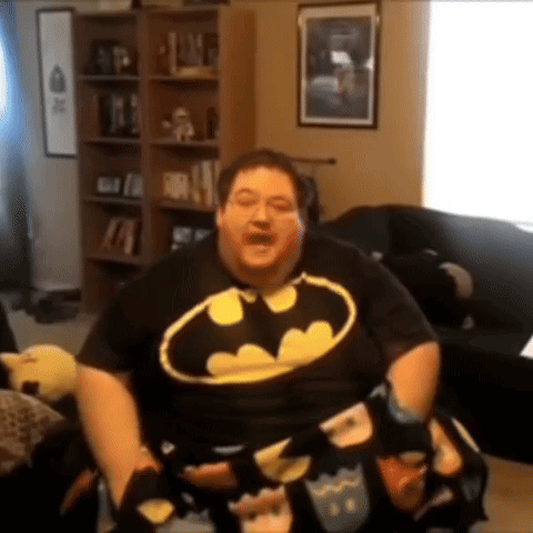 Man In Batman Shirt Sitting GIF