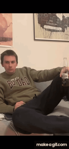 Man In Be Dad Sweater Holding Corona