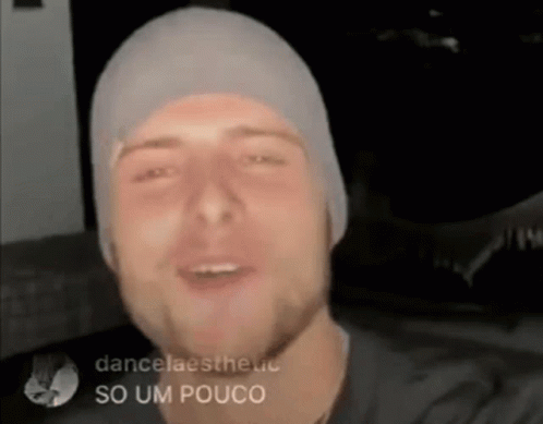 Man in Beanie and Black Shirt Smiling and Talking