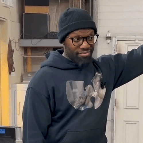 Man In Beanie And Glasses Wearing Wu Tang Hoodie GIF