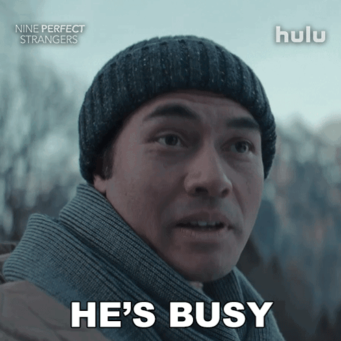 Man in Beanie and Scarf Says He's Busy
