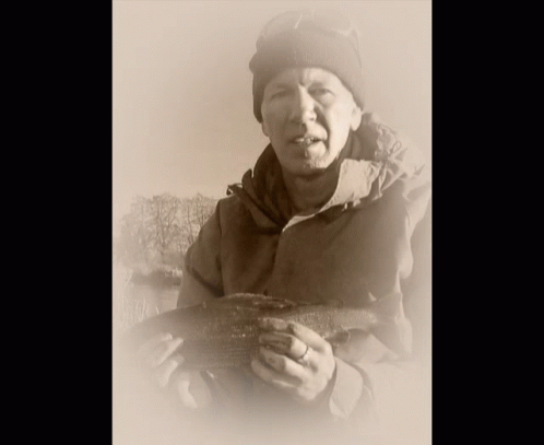 Man in Beanie Holding Large Fish