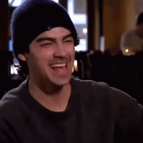 Man In Beanie Laughing With Eyes Closed GIF