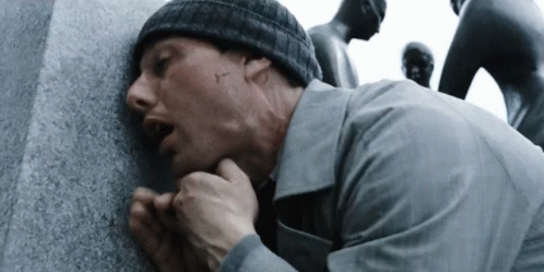 Man In Beanie Leaning Against Wall With Mouth Open GIF