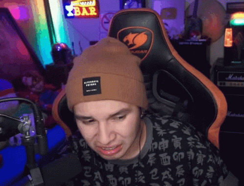 Man In Beanie Sitting In Chair With Bar Sign GIF