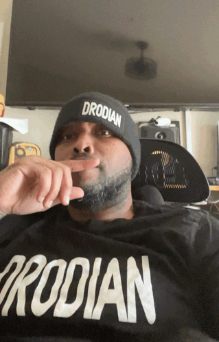 Man in Beanie Wearing Drodilan Shirt