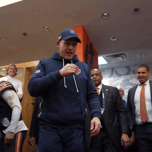 Man In Bear Sweatshirt In Locker Room GIF