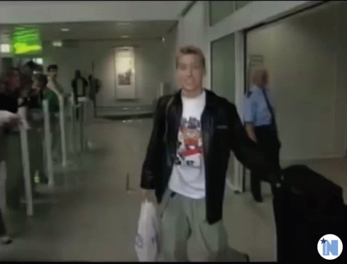 Man in Bear T-shirt Walking Down Hallway