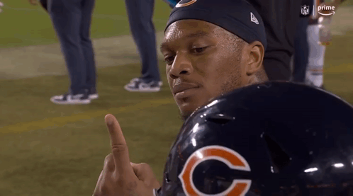 Man in Bears Helmet Giving Middle Finger on Football Field