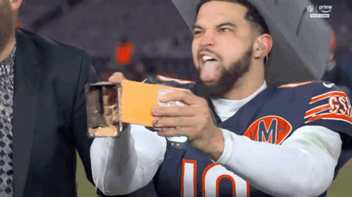 Man in Bears Jersey Holding Card