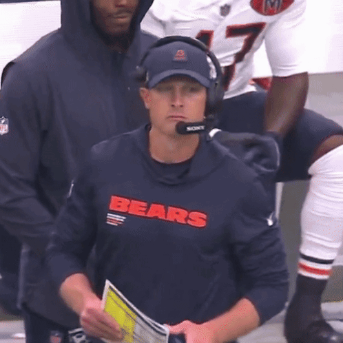 Man In Bears Shirt And Headphones Looking At Camera GIF