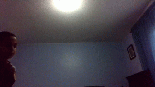 Man in Bedroom with Ceiling Light