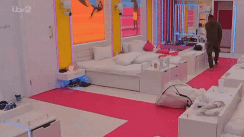 Man in Bedroom with Pink Rug and ITV 2 Screen