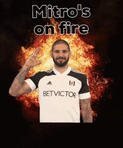 Man In Bet Victor Shirt In Front Of Flames GIF