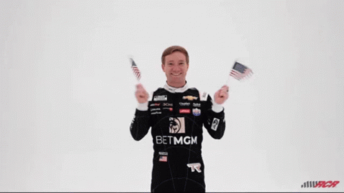 Man in Betmgm Shirt Holding Two American Flags