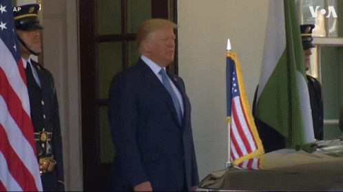 Man in BetMGM Shirt Holding Two American Flags
