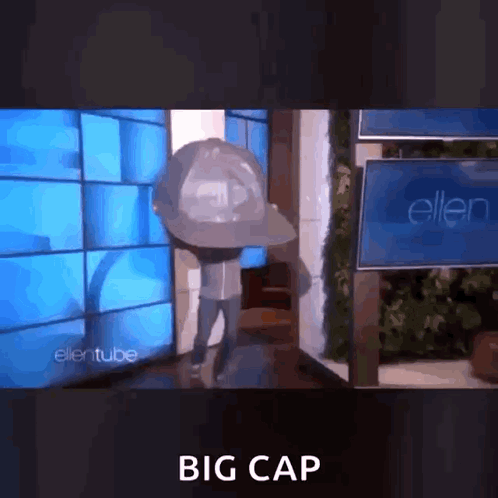 Man in Big Hat in Front of Ellentube Sign