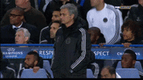 Man In Black Adidas Jacket In Front Of Champions League Sign GIF
