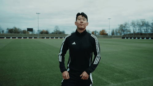 Man in Black Adidas Jacket on Soccer Field