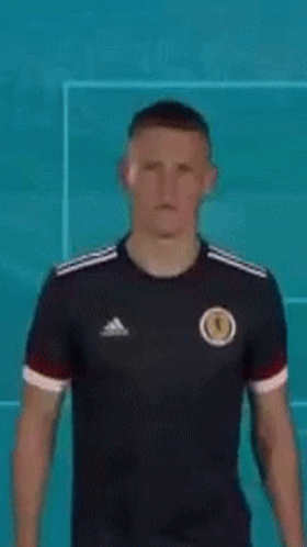 Man in Black Adidas Jersey by Blue Wall
