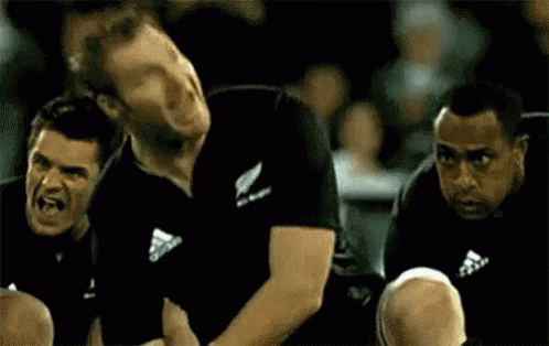 Man in Black Adidas Shirt Sitting Next to Man
