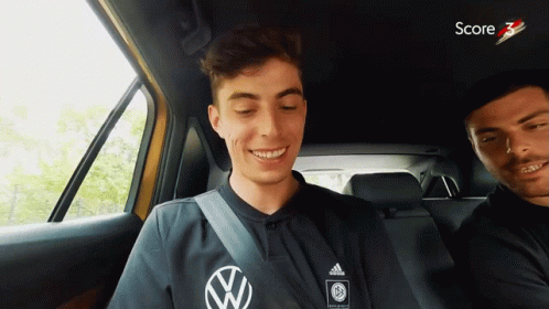 Man in Black Adidas Shirt Smiling in Car