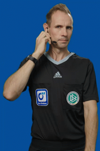 Man in Black Adidas Shirt Talking on Phone