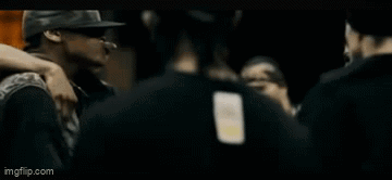 Man In Black Adidas Shirt Talking To Man In Hat GIF