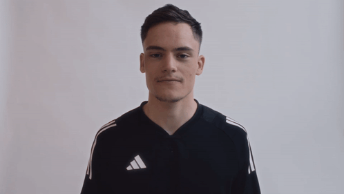 Man in Black Adidas Shirt With White Stripes