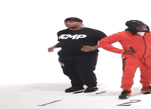 Man in Black Amp Shirt Next to Man in Red Jumpsuit
